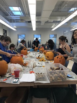 Art Club carving pumpkins